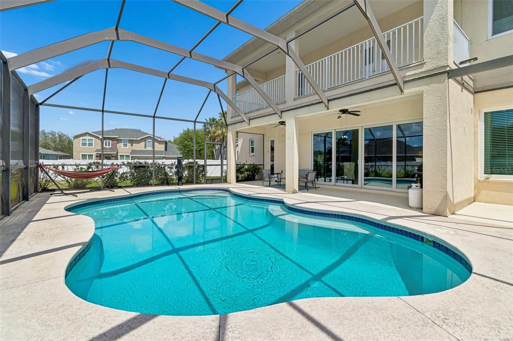 11830 Newberry Grove Loop Riverview, FL 33579 - Photo 50 of 58 a view of a patio with a table and chairs under an umbrella