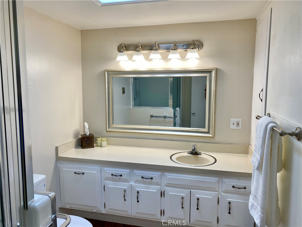 1312 Golden Rain Road Seal Beach, CA 90740 - Photo 3 of 38 bathroom with modern vanity light fixture and skylight