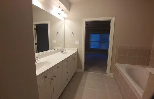 a bathroom with a bathtub and a sink