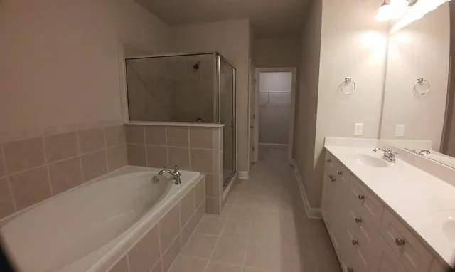 a spacious bathroom with a bathtub and a sink