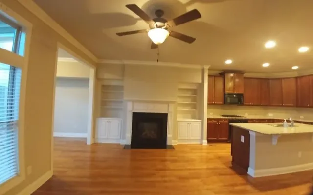 a view of a kitchen with a sink and a fireplace