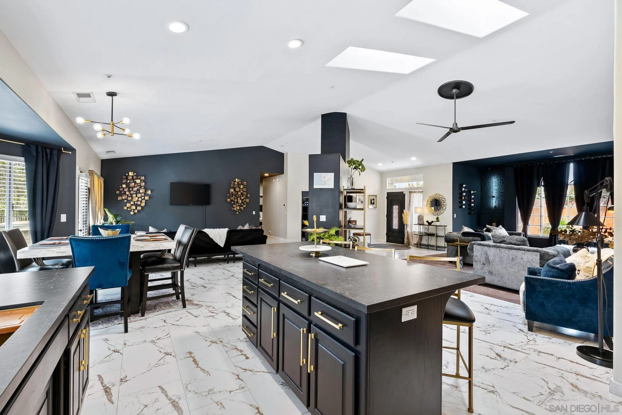624 Rowley Way Ramona, CA 92065 - Photo 17 of 54 a kitchen with a table chairs and flat screen tv