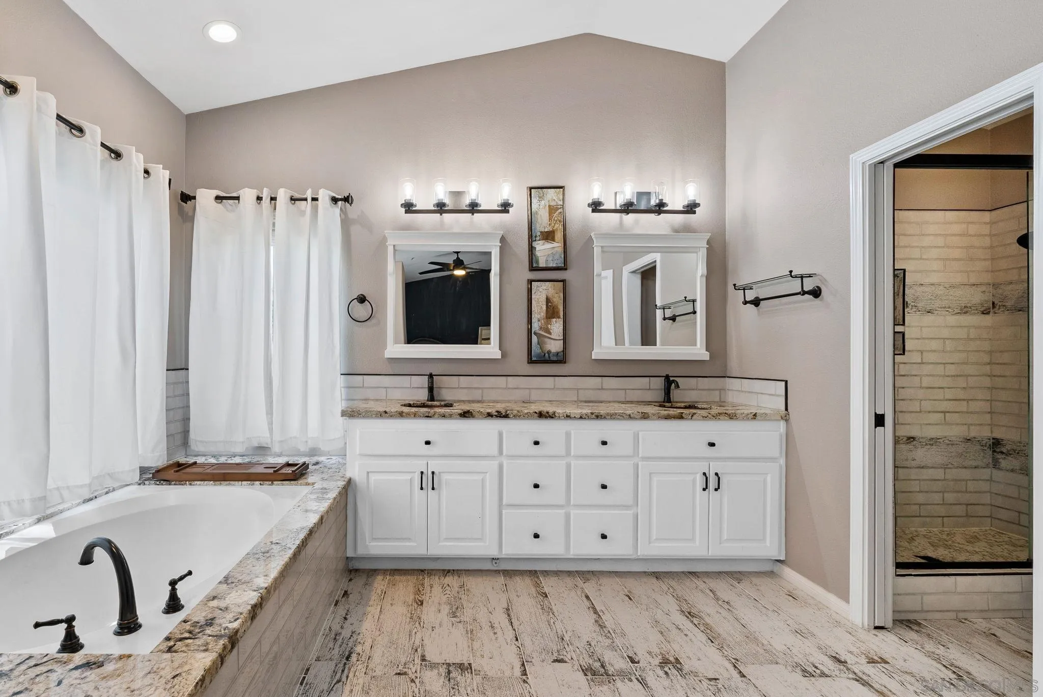 624 Rowley Way Ramona, CA 92065 - Photo 34 of 54 a bathroom with double vanity sinks a mirror and a shower