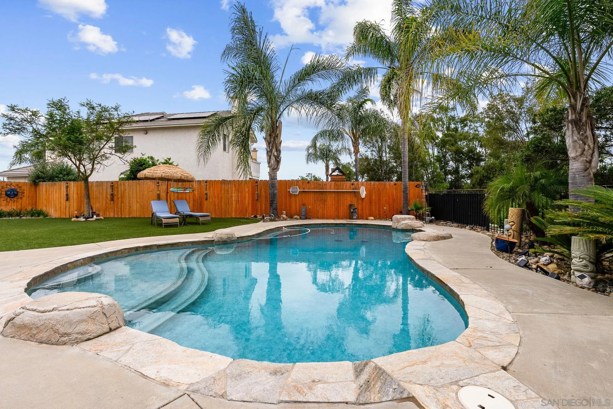 624 Rowley Way Ramona, CA 92065 - Photo 41 of 54 a view of a swimming pool with a yard and palm trees