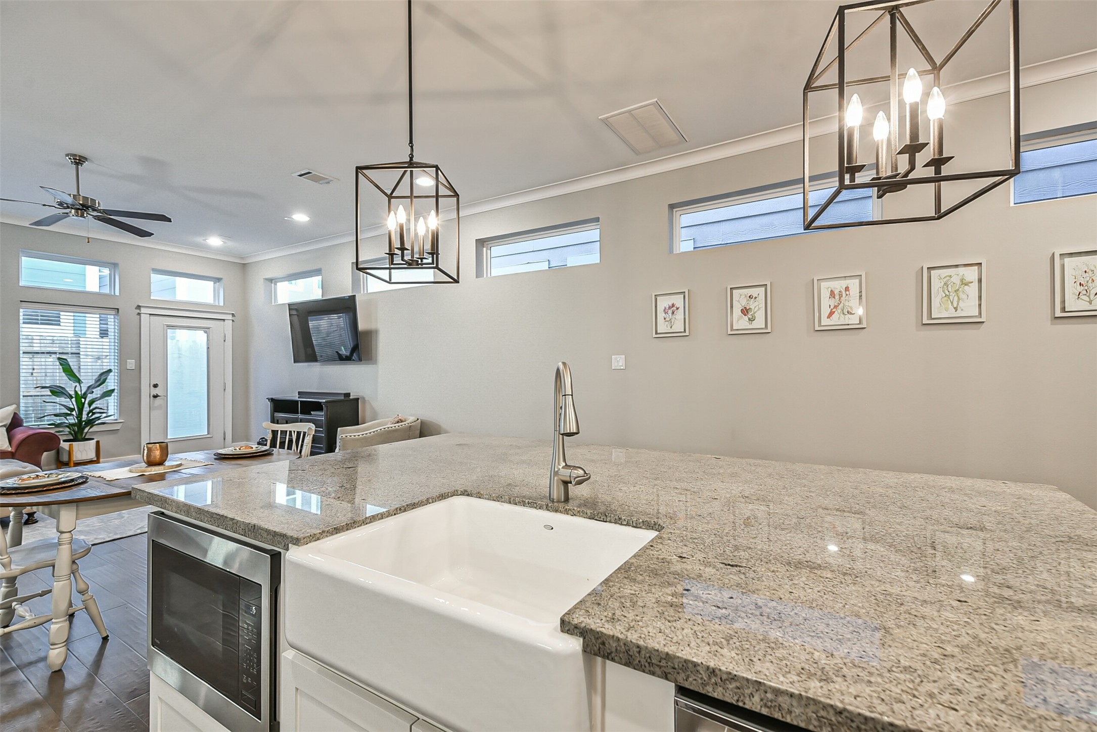 3222 Gillespie Street Houston, TX 77020 - Photo 22 of 43 a kitchen with a sink chandelier and living room view