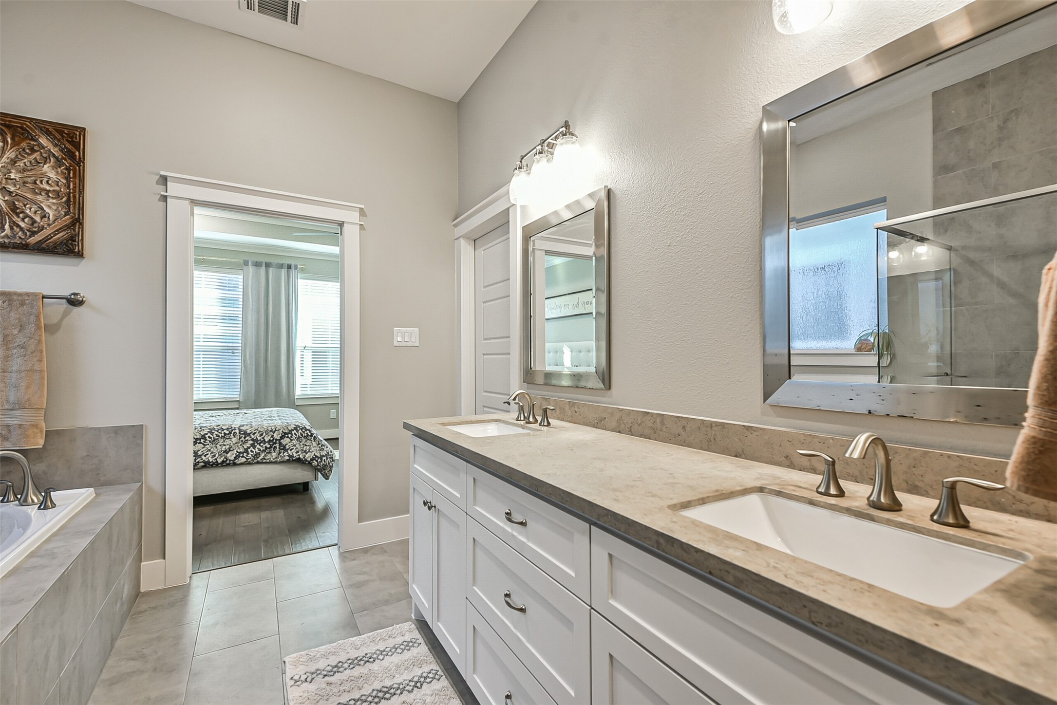 3222 Gillespie Street Houston, TX 77020 - Photo 42 of 43 a spacious bathroom with a granite countertop tub and a double vanity sink mirror