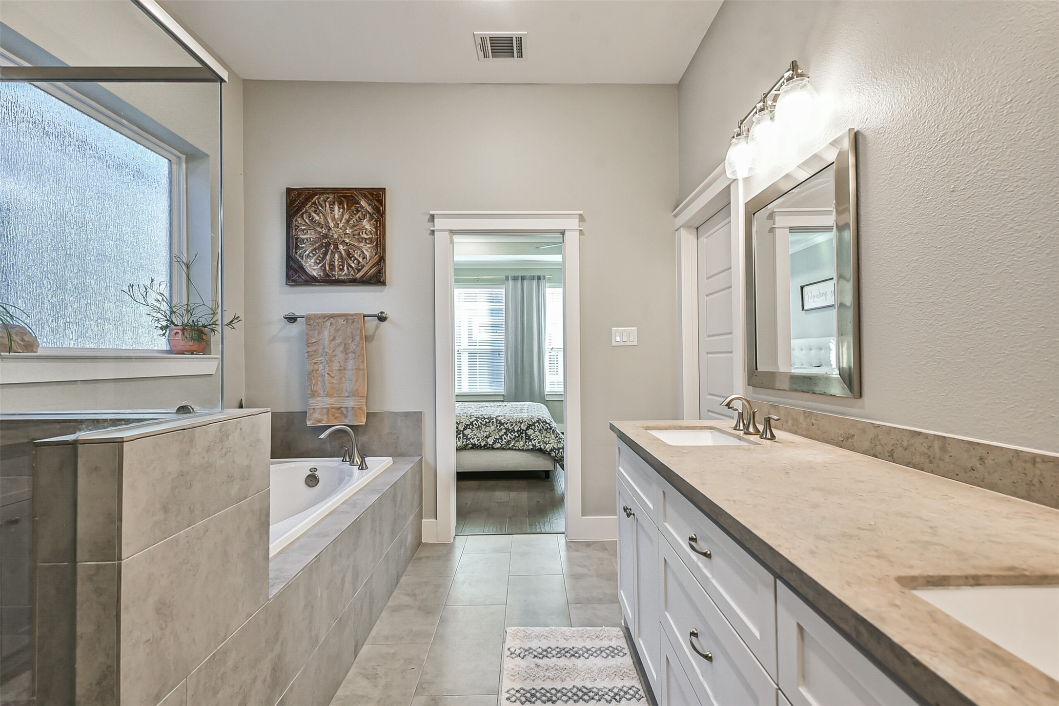 3222 Gillespie Street Houston, TX 77020 - Photo 43 of 43 a spacious en suite bathroom with a granite countertop tub and 2 sink