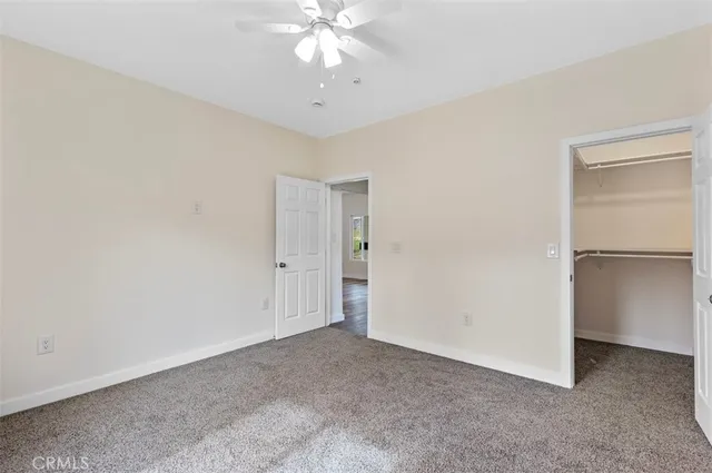 a view of an empty room with a fan