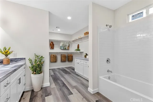 a bathroom with a granite countertop sink a toilet and shower