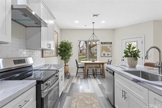 a kitchen with a table and chairs in it