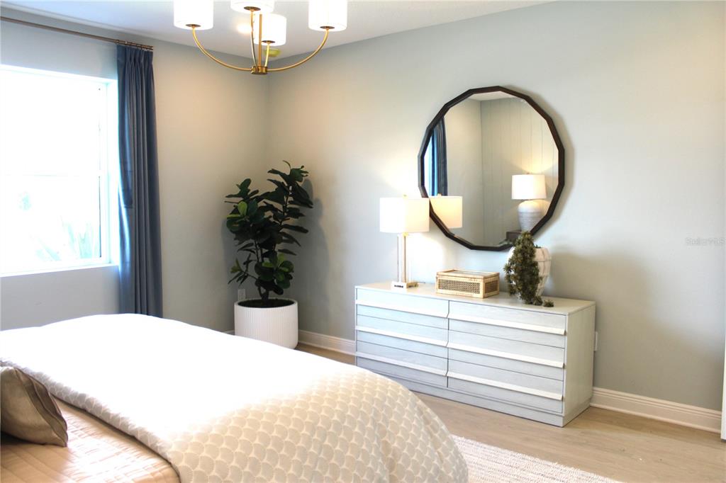 17724 Broadleaf Loop Venice, FL 34293 - Photo 16 of 19 a bedroom with a bed and a mirror