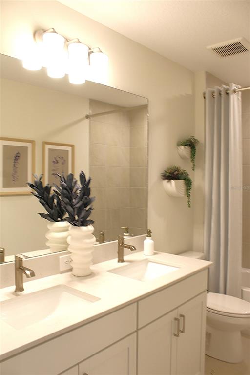 17724 Broadleaf Loop Venice, FL 34293 - Photo 17 of 19 a bathroom with a sink and a mirror