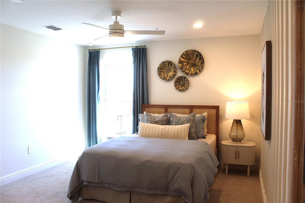 17724 Broadleaf Loop Venice, FL 34293 - Photo 18 of 19 a bedroom with a bed and a chandelier