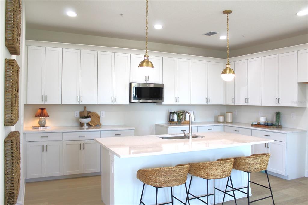 17724 Broadleaf Loop Venice, FL 34293 - Photo 4 of 19 a kitchen with a sink window and cabinets