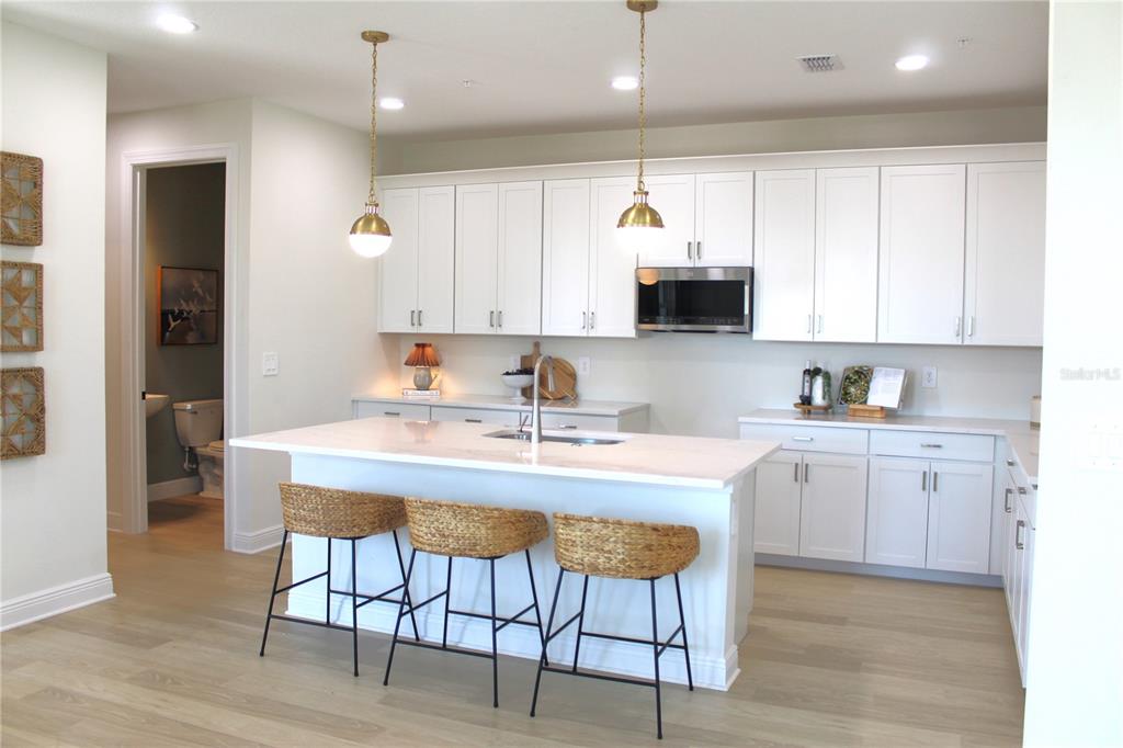 17724 Broadleaf Loop Venice, FL 34293 - Photo 5 of 19 a kitchen with a sink cabinets and wooden floor