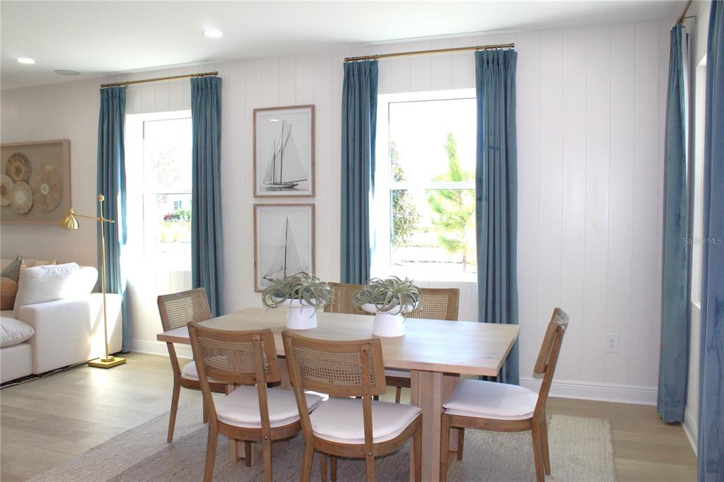 17724 Broadleaf Loop Venice, FL 34293 - Photo 7 of 19 a view of a dining room with furniture window and wooden floor