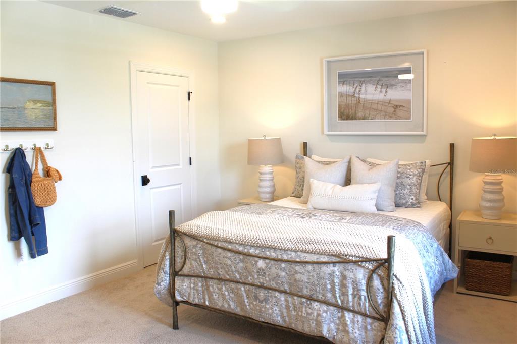 17724 Broadleaf Loop Venice, FL 34293 - Photo 10 of 19 a bedroom with a bed and a painting on the wall