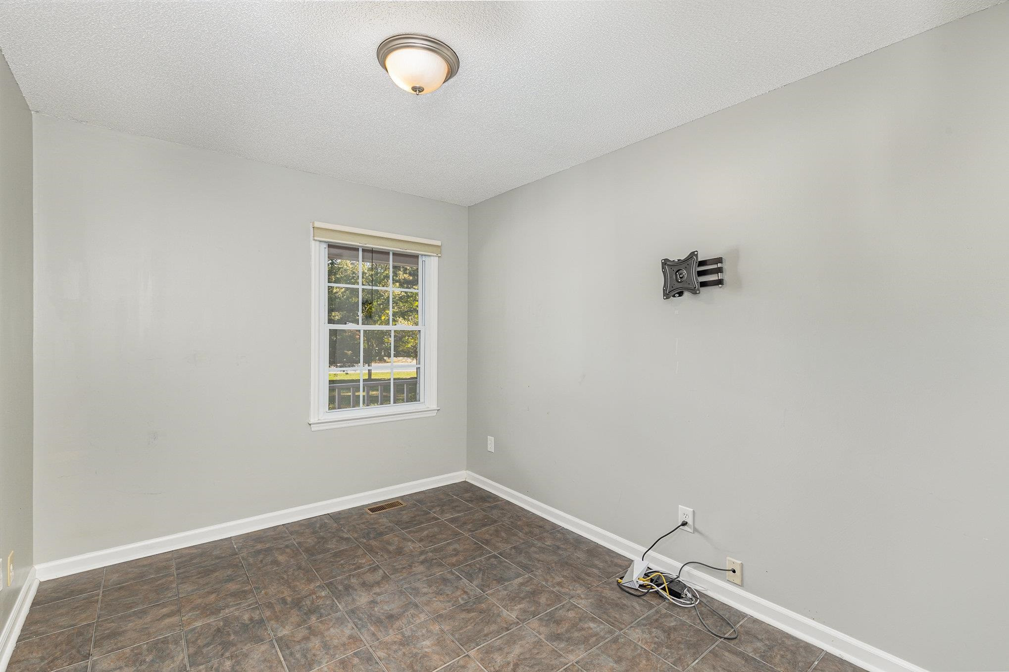 8724 Walter Myatt Road Willow Spring, NC 27592 - Photo 12 of 24 an empty room with windows and cabinet
