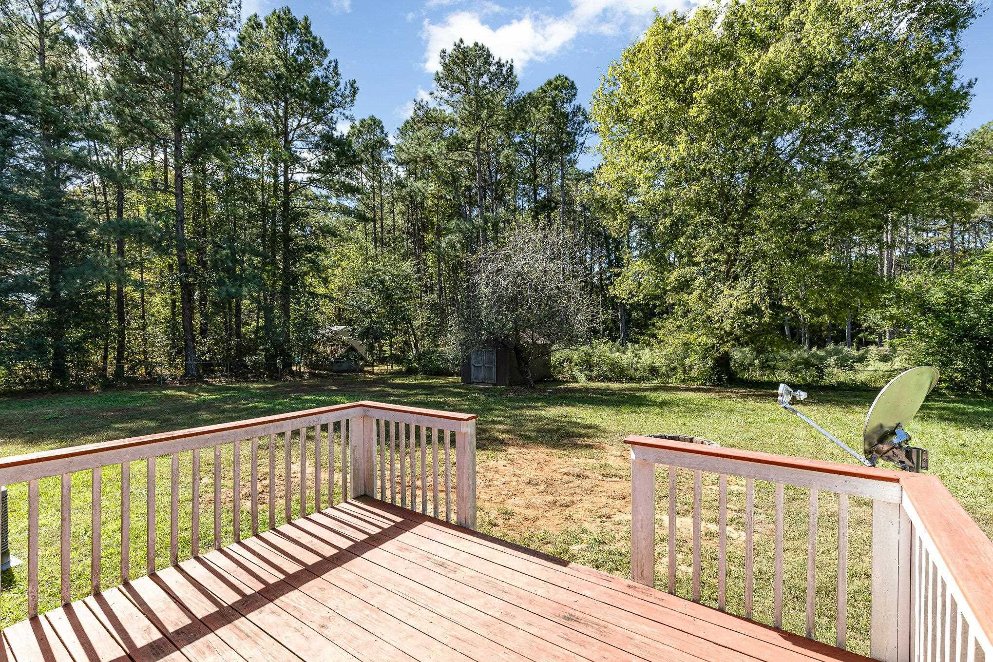 8724 Walter Myatt Road Willow Spring, NC 27592 - Photo 18 of 24 a view of balcony with wooden floor and fence