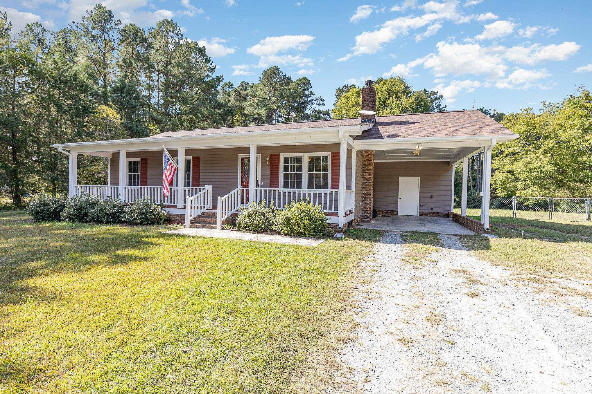 8724 Walter Myatt Road Willow Spring, NC 27592 - Photo 3 of 24 a view of a house with pool and chairs