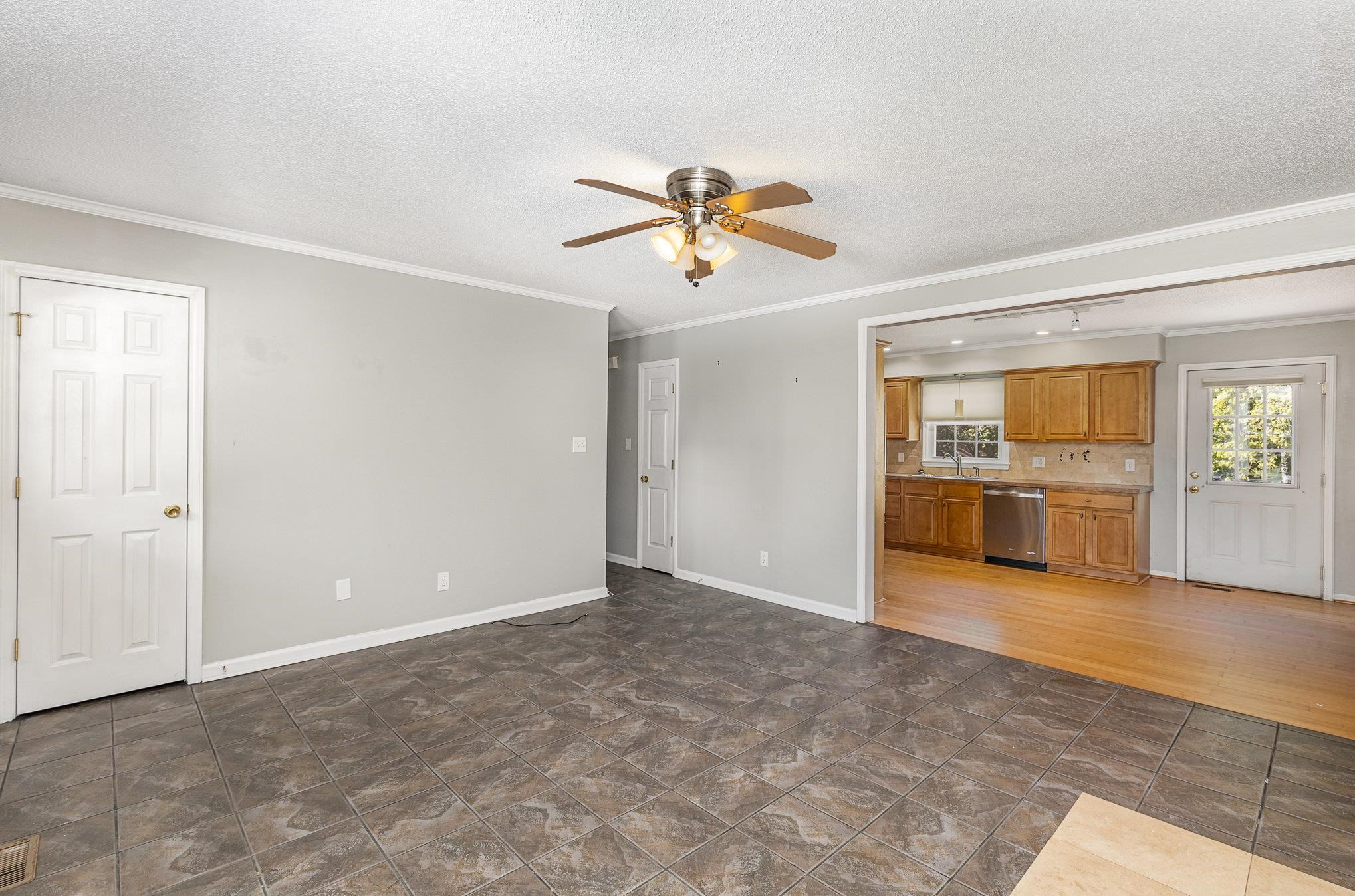 8724 Walter Myatt Road Willow Spring, NC 27592 - Photo 5 of 24 an empty room with chandelier fan and windows