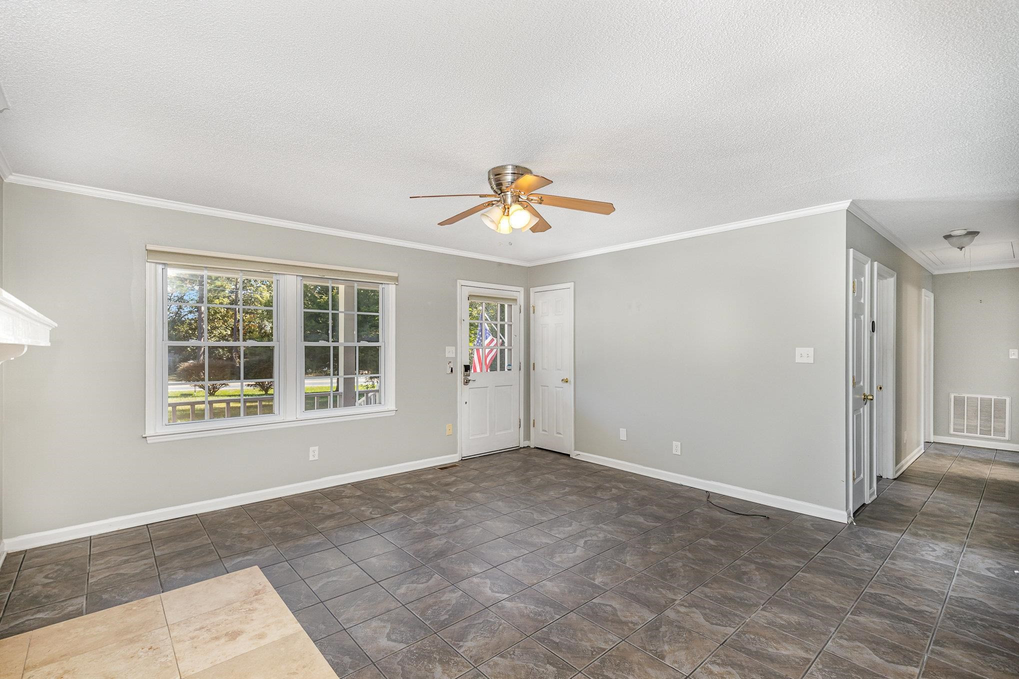 8724 Walter Myatt Road Willow Spring, NC 27592 - Photo 6 of 24 an empty room with window and a ceiling fan