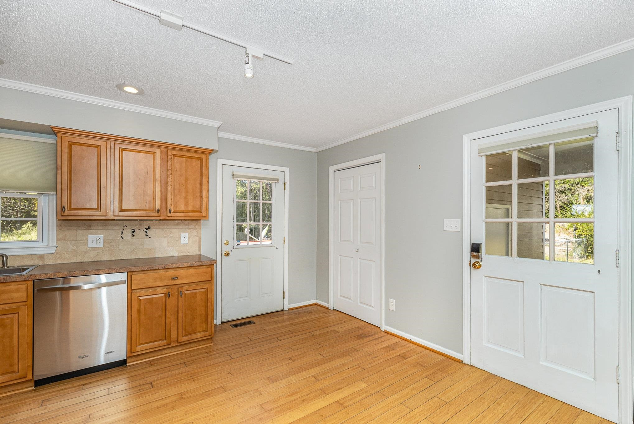 8724 Walter Myatt Road Willow Spring, NC 27592 - Photo 8 of 24 a view of a kitchen with wooden floor and electronic appliances