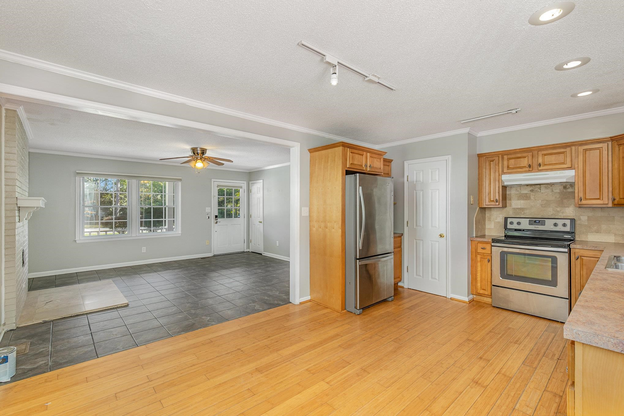8724 Walter Myatt Road Willow Spring, NC 27592 - Photo 9 of 24 a view of a kitchen with wooden floor and electronic appliances