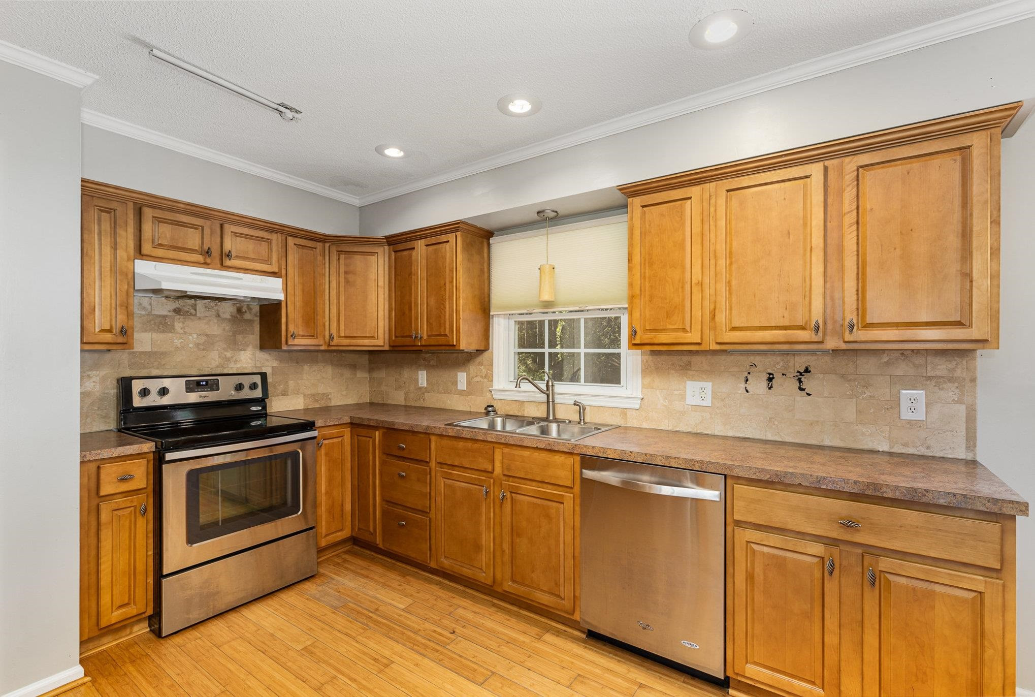 8724 Walter Myatt Road Willow Spring, NC 27592 - Photo 10 of 24 a kitchen with stainless steel appliances granite countertop a stove a sink and a microwave
