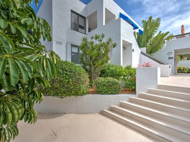 a view of a house with potted plants