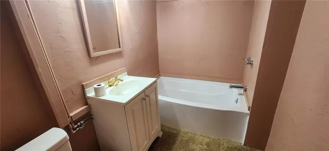 a bathroom with a bathtub sink and toilet