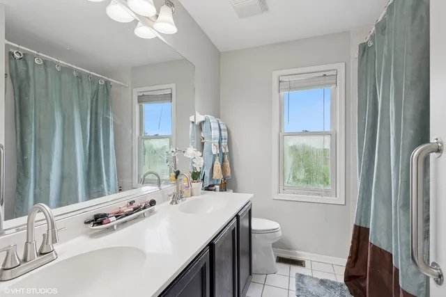 a bathroom with a double vanity sink and a mirror