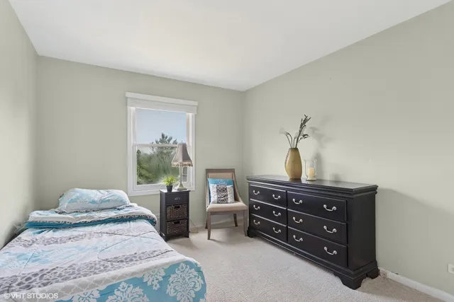 a bedroom with a bed and a dresser