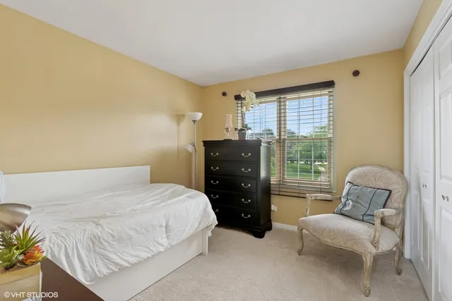 a bedroom with a bed and chair