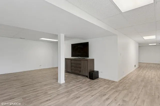 a view of a livingroom with wooden floor and a flat screen tv