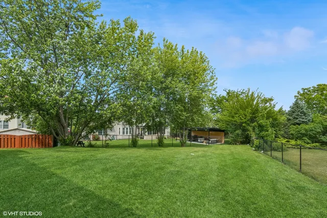 a view of green field with trees in the background