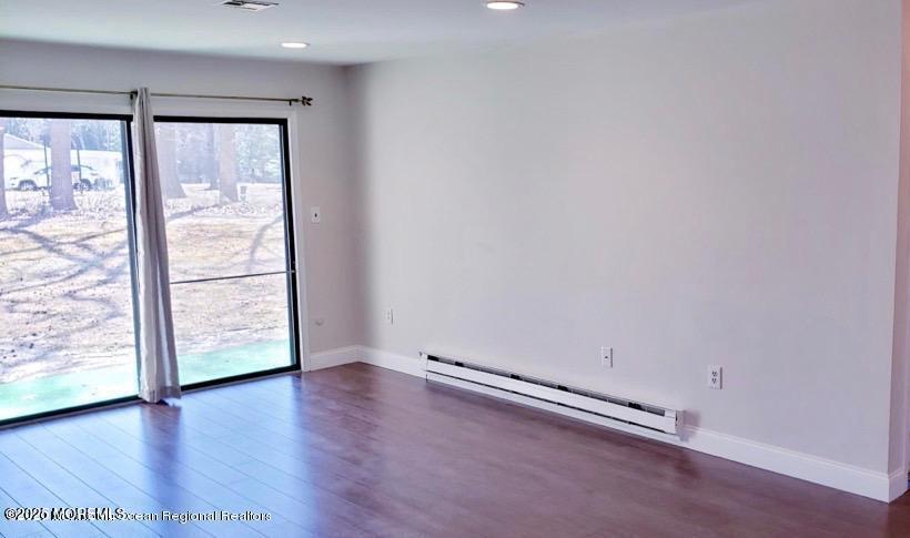 102 Arrowood Road, Unit A Manalapan, NJ 07726 - Photo 2 of 11 an empty room with wooden floor and windows