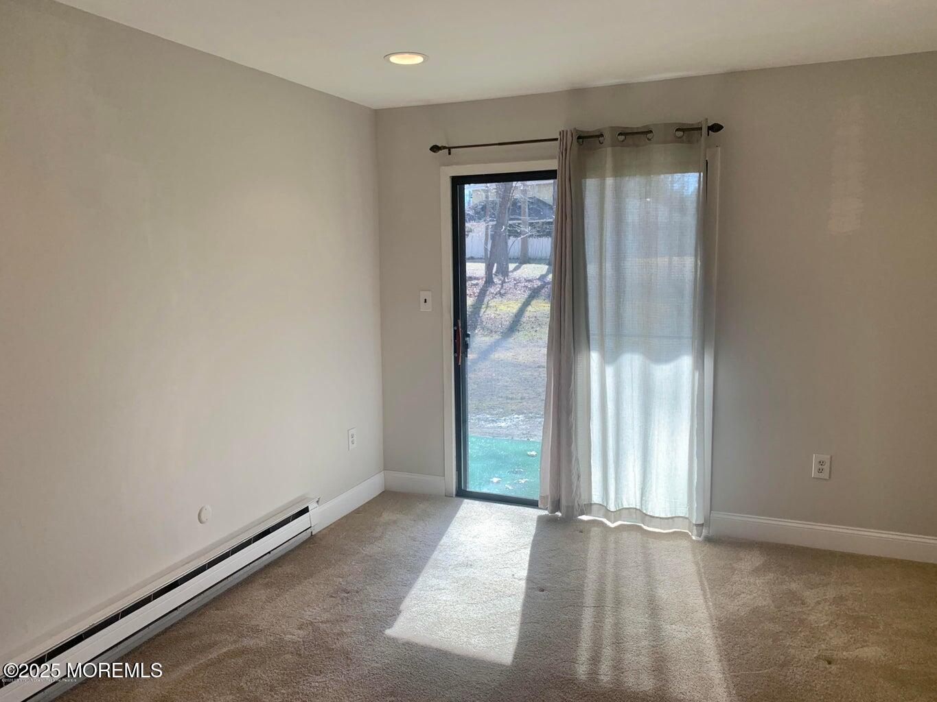 102 Arrowood Road, Unit A Manalapan, NJ 07726 - Photo 7 of 11 an empty room with window
