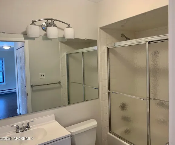 a bathroom with a shower and toilet