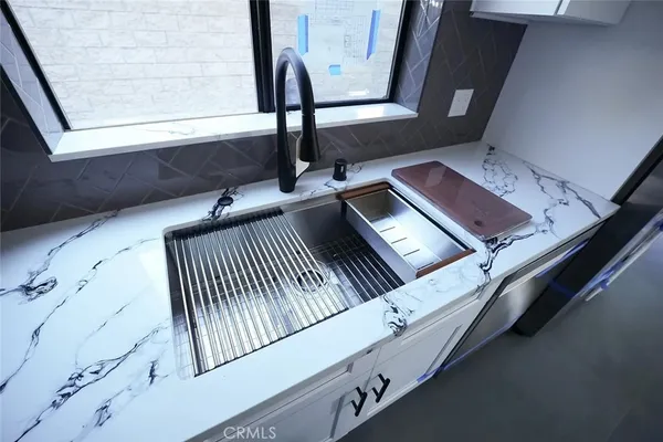 a kitchen with stainless steel appliances a stove top oven