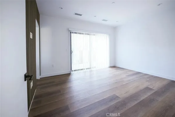 a view of hallway with wooden floor