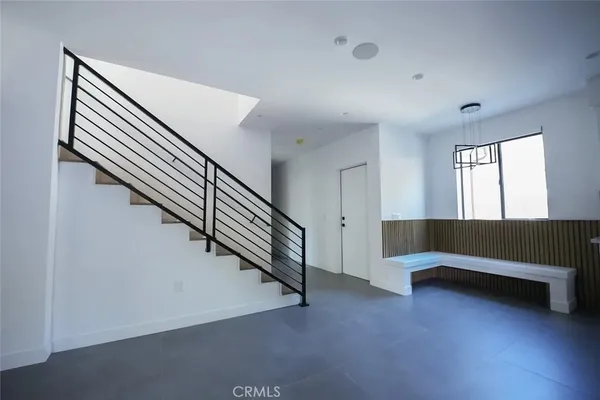 a view of room with stairs and wooden floor