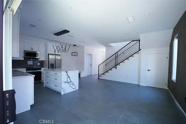 a view of kitchen with furniture and wooden floor