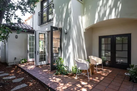 a view of a patio with table and chairs and potted plants