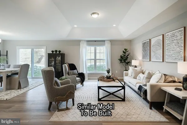 a living room with furniture wooden floor and a window