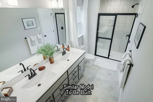 a bathroom with a sink and mirror with toilet
