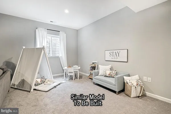a living room with furniture a window and a table