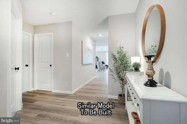 a view of living room with furniture and a mirror