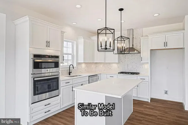 a kitchen with a stove a sink and a refrigerator