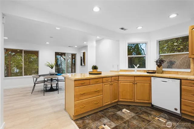 a view of a dining room with furniture and a large window